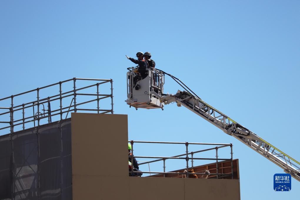 9月1日，在日本神奈川縣相模原市，消防員演練用消防云梯車(chē)救下被困高樓的民眾。9月1日是日本防災(zāi)日。當(dāng)天，日本中央政府及多個(gè)都縣市舉行了防災(zāi)演練，以提高大規(guī)模災(zāi)害發(fā)生時(shí)防災(zāi)機(jī)構(gòu)和市民迅速應(yīng)對(duì)的能力。新華社記者 楊光 攝