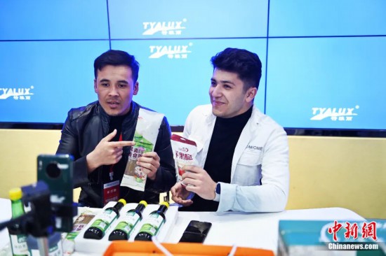 2023年3月，甘肅省慶陽市環(huán)縣電商創(chuàng)業(yè)孵化基地內(nèi)，來自蘭州文理學(xué)院的塔吉克斯坦留學(xué)生正在協(xié)助主播直播帶貨當(dāng)?shù)剞r(nóng)特產(chǎn)品。李亞龍 攝