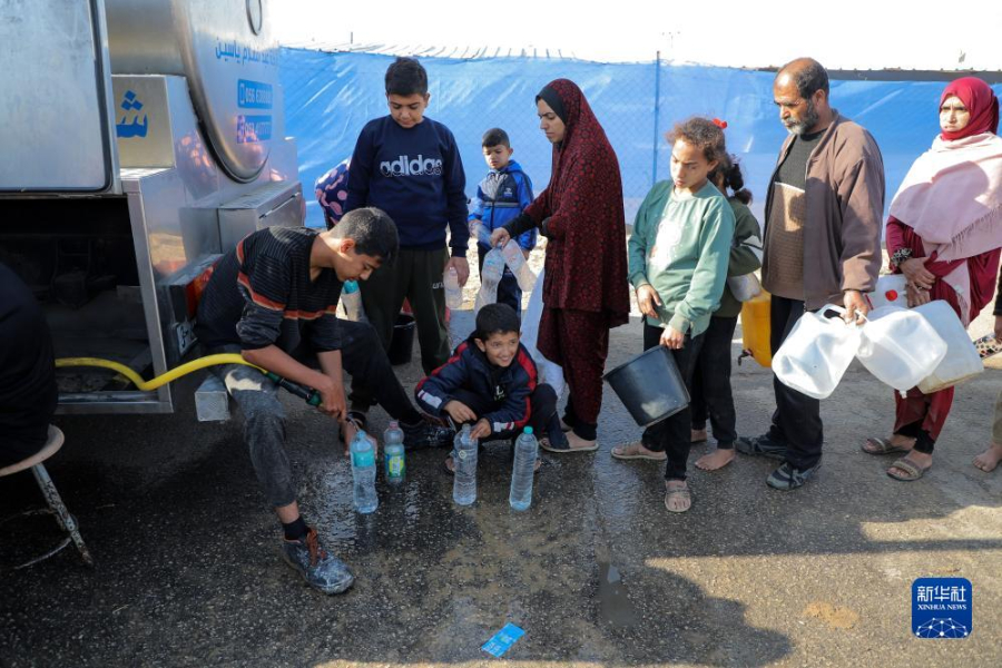 12月8日，在加沙地帶南部城市拉法一處臨時(shí)營(yíng)地內(nèi)，人們排隊(duì)打水。新華社發(fā)（里澤克·阿卜杜勒賈瓦德 攝）