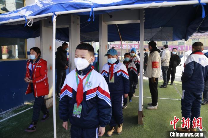 圖為學(xué)生測(cè)量體溫后進(jìn)入校園。　馬銘言 攝