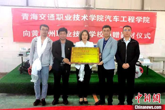 圖為李富香(中)代表學校為州縣技校捐贈器材。(資料圖) 青海省教育廳供圖