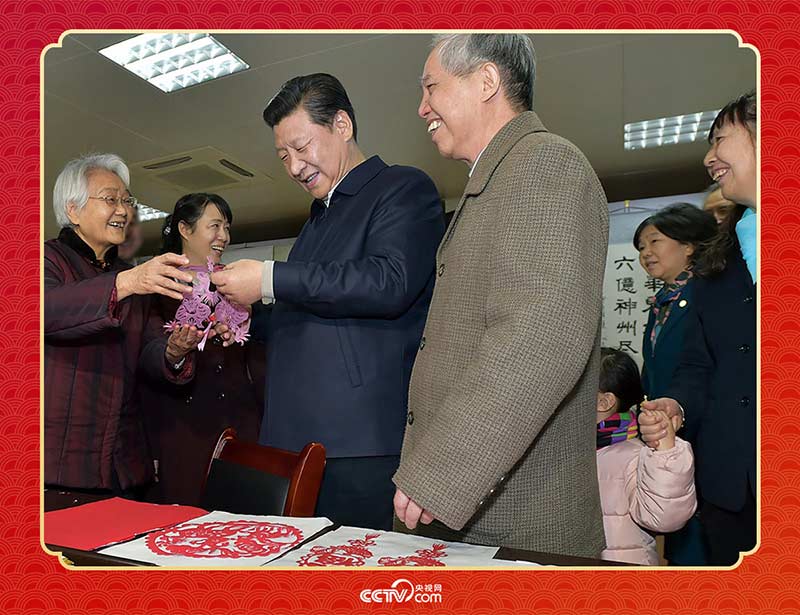 2015年2月15日，習近平在西安市雁塔區(qū)電子城街道二〇五所社區(qū)服務中心欣賞社區(qū)居民的剪紙作品。
