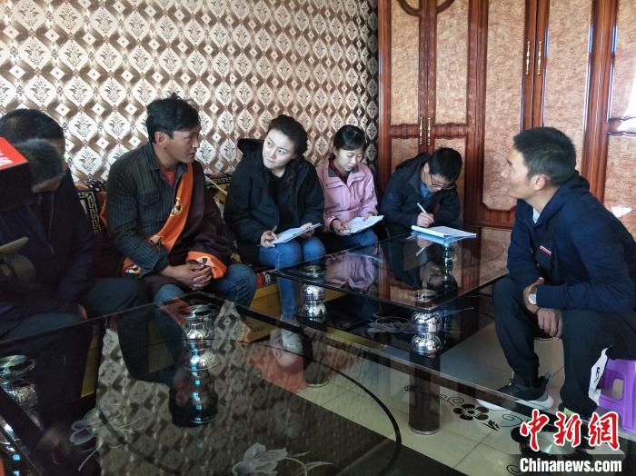 圖為調(diào)查組工作人員正在入戶調(diào)查。　祁增蓓 攝