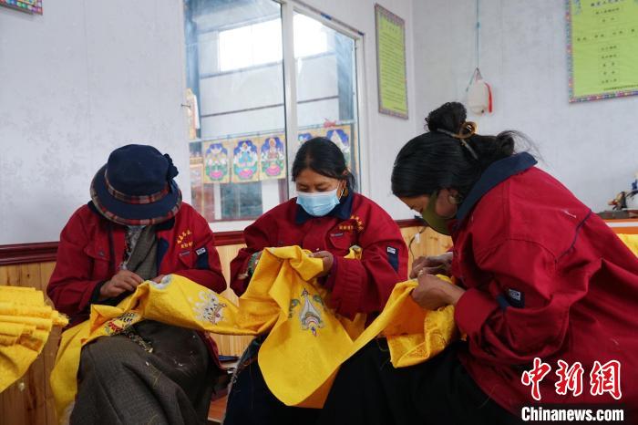 圖為工人正在制作哈達?！●R銘言 攝